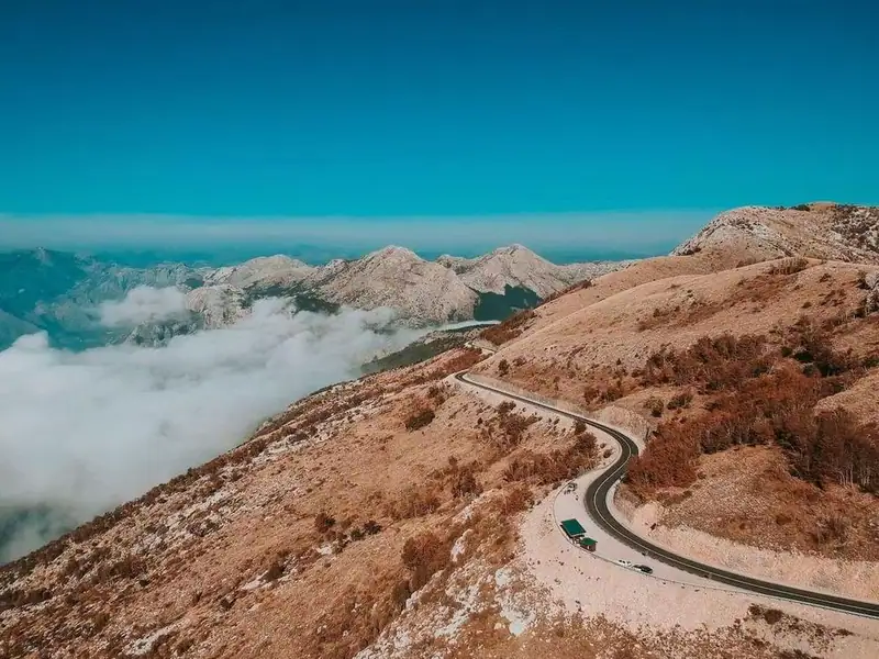 A mountain road above the clouds near the bay