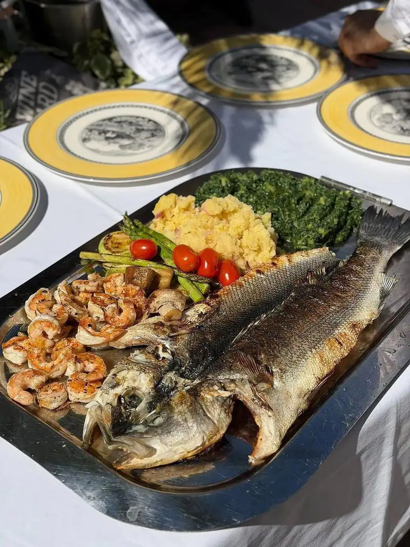 Grilled sea bass, shrimp and Swiss chard on a platter